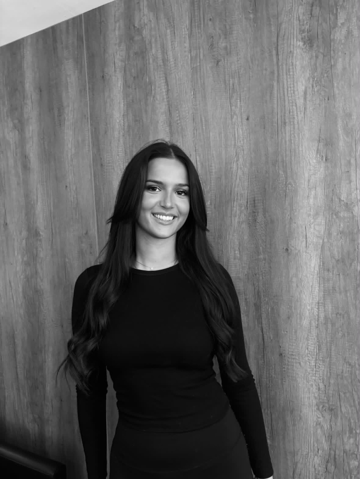Black-and-white portrait of the stylist behind DKM HAIR